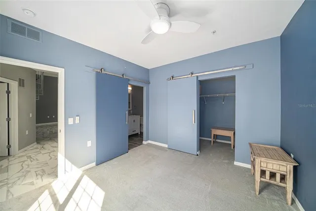 a bedroom with a bed and a chair