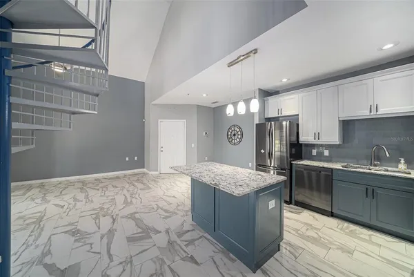 a kitchen with stainless steel appliances granite countertop a sink stove and cabinets