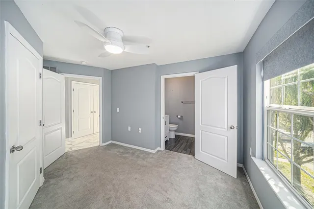 an empty room with windows and closet