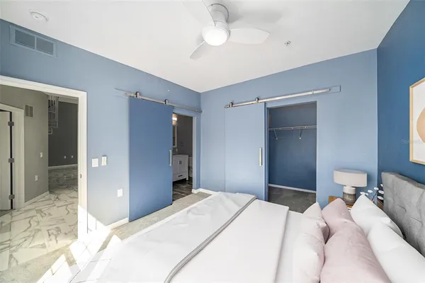 a bedroom with a bed and a chandelier