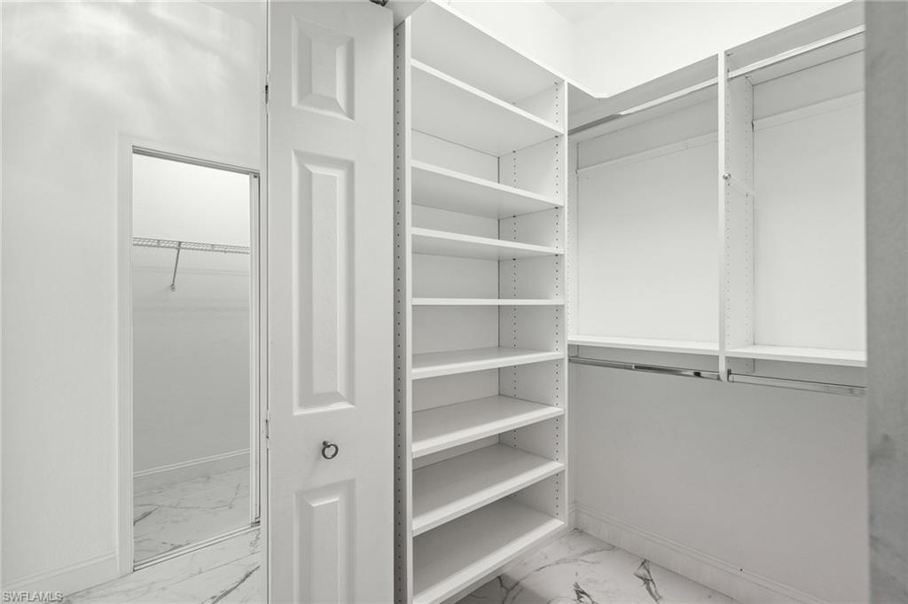 3972 Ruxton Road Naples, FL 34116 - Photo 24 of 41 a view of walk in closet with empty racks