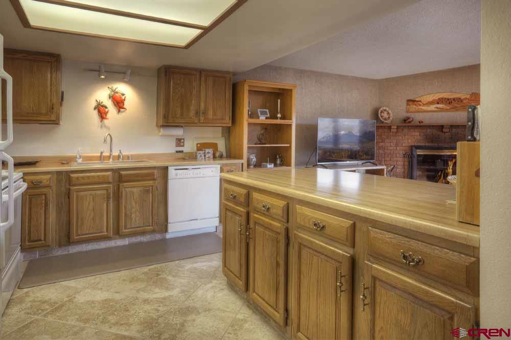 322 Sheol Street, Unit 7 Durango, CO 81301 - Photo 14 of 35 a kitchen with cabinets a sink and appliances