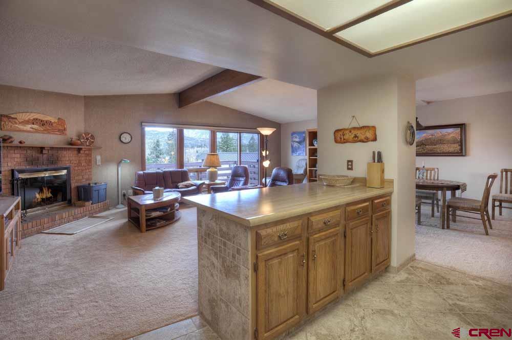 322 Sheol Street, Unit 7 Durango, CO 81301 - Photo 16 of 35 a living room with furniture a fireplace and a large window