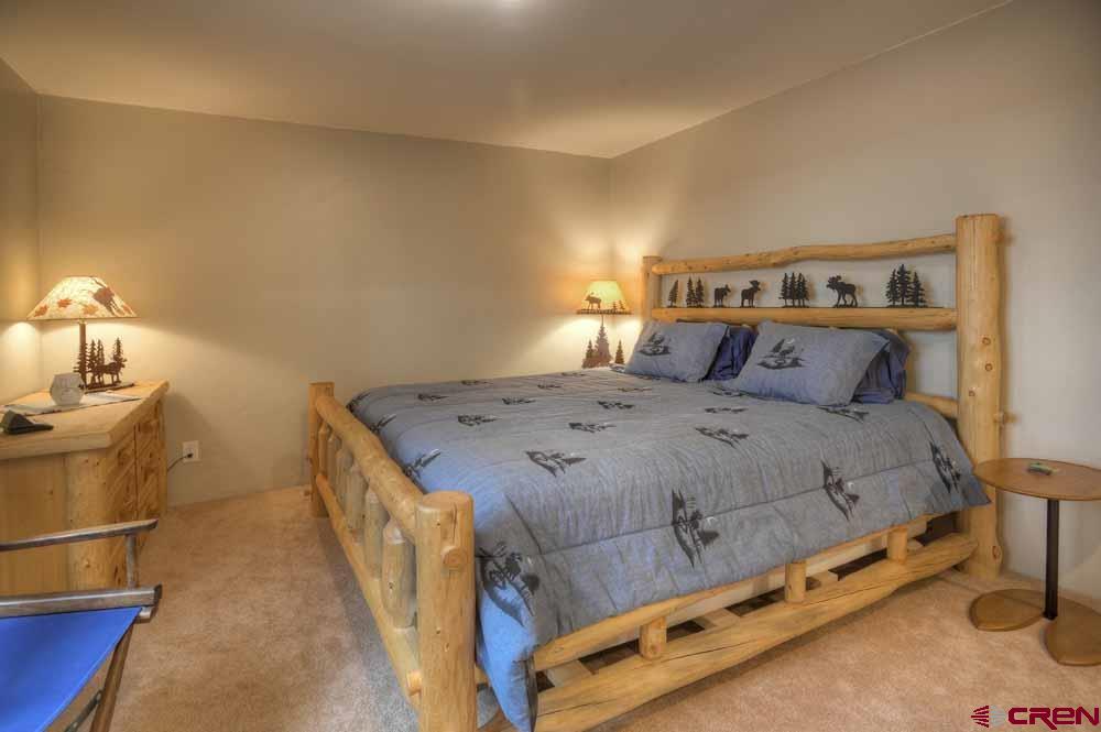 322 Sheol Street, Unit 7 Durango, CO 81301 - Photo 17 of 35 a bedroom with a bed and a table