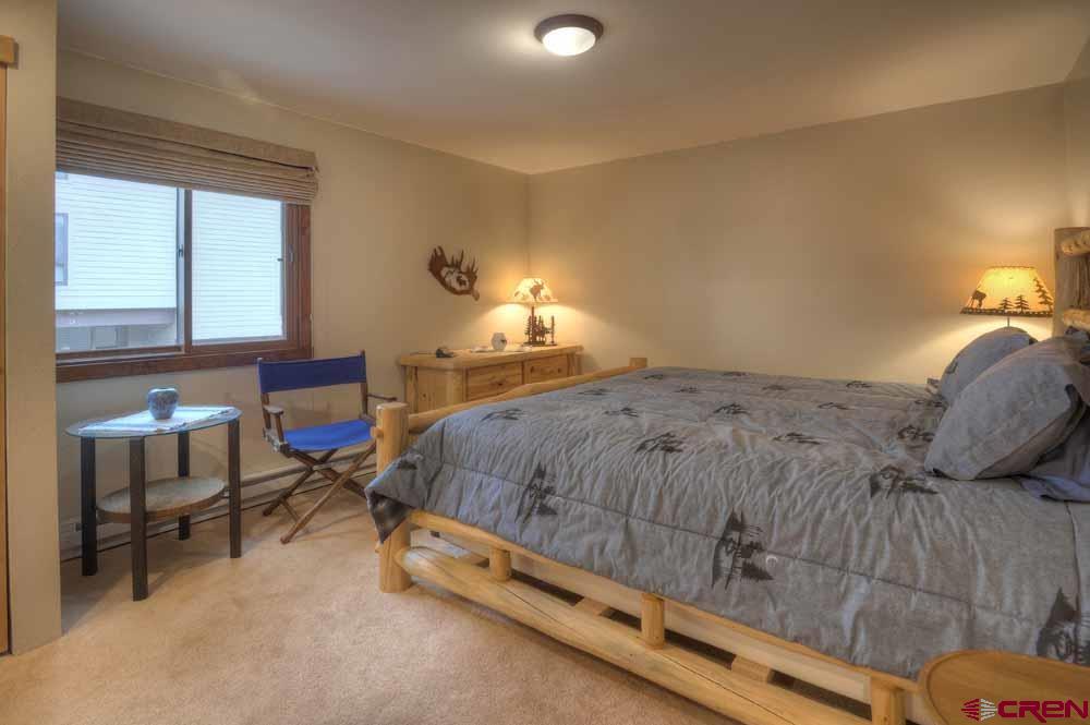 322 Sheol Street, Unit 7 Durango, CO 81301 - Photo 18 of 35 a bed sitting in a bedroom next to a window