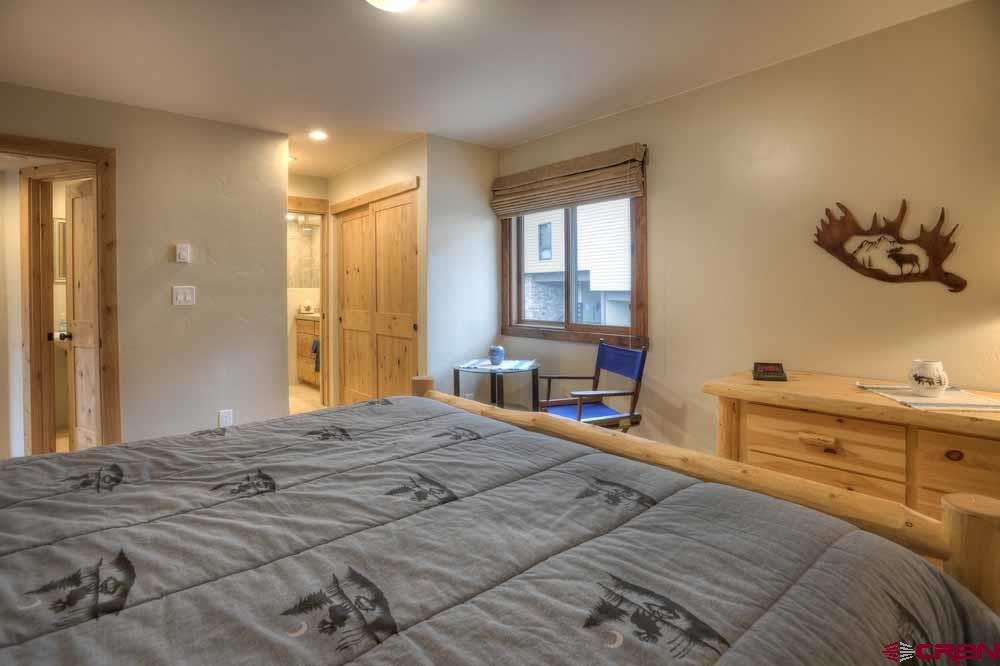 322 Sheol Street, Unit 7 Durango, CO 81301 - Photo 19 of 35 a bedroom with a bed and wooden floor