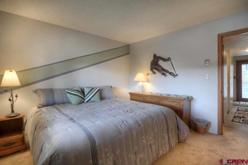 322 Sheol Street, Unit 7 Durango, CO 81301 - Photo 23 of 35 a bedroom with a bed and window