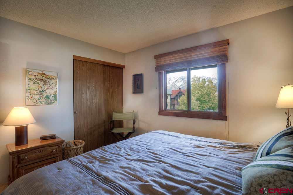 322 Sheol Street, Unit 7 Durango, CO 81301 - Photo 24 of 35 a bedroom with a bed and a window