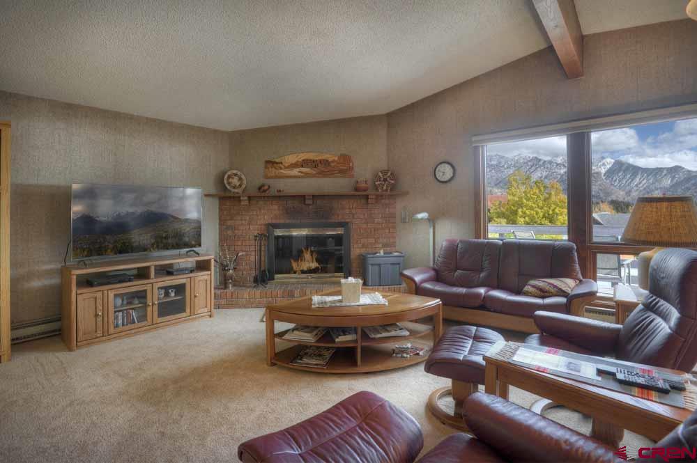 322 Sheol Street, Unit 7 Durango, CO 81301 - Photo 5 of 35 a living room with furniture flat screen tv and a fireplace