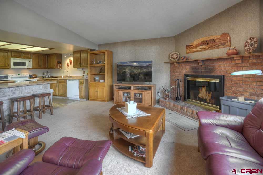 322 Sheol Street, Unit 7 Durango, CO 81301 - Photo 6 of 35 a living room with furniture and a fireplace