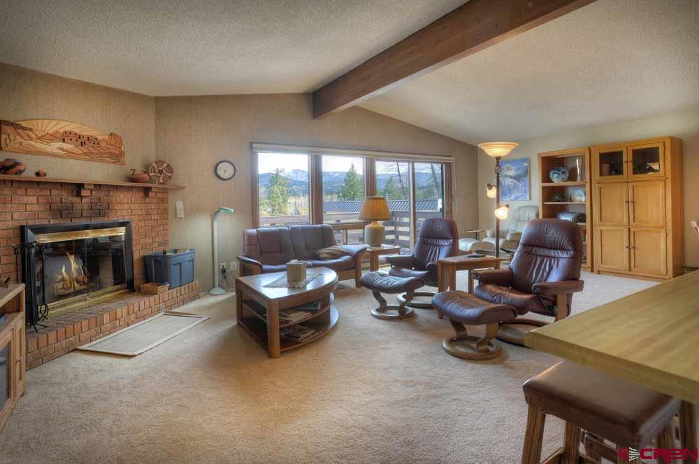 322 Sheol Street, Unit 7 Durango, CO 81301 - Photo 7 of 35 a living room with furniture large window and a fireplace