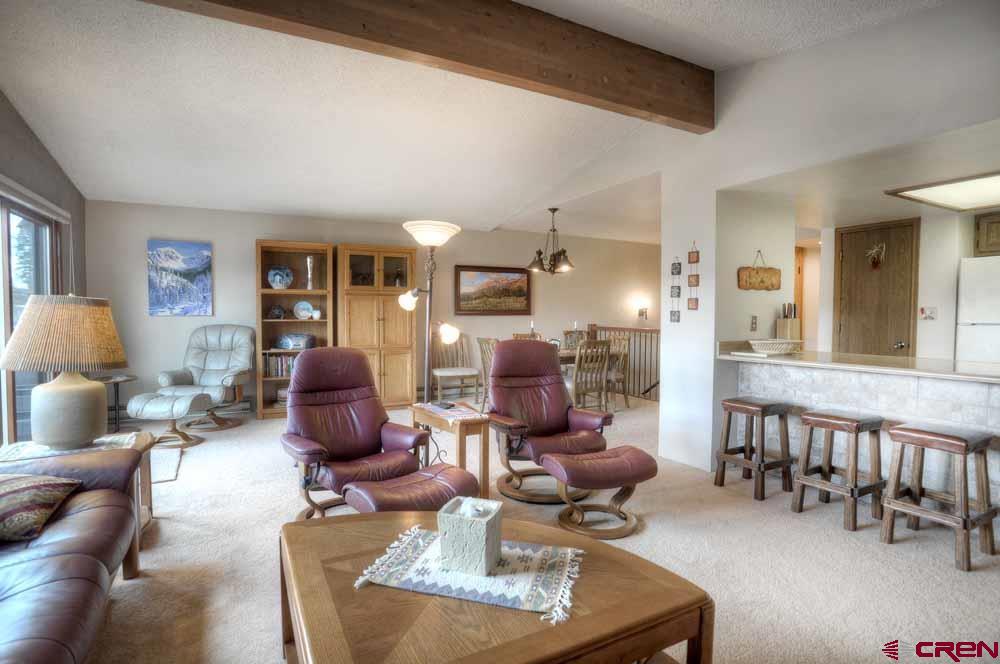 322 Sheol Street, Unit 7 Durango, CO 81301 - Photo 10 of 35 a living room with furniture chess board and a large window