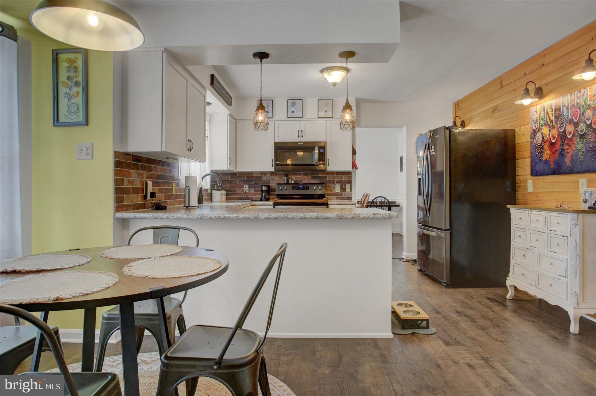 65 Ridgeview Drive Etters, PA 17319 - Photo 13 of 50 a kitchen with a table chairs refrigerator and microwave