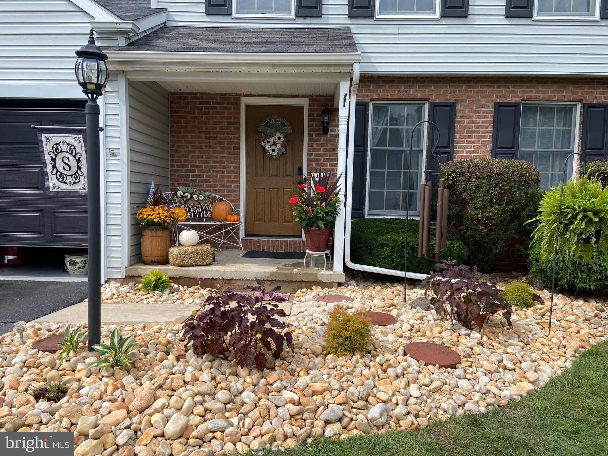 65 Ridgeview Drive Etters, PA 17319 - Photo 50 of 50 a view of a house with potted plants and a bench in front of it