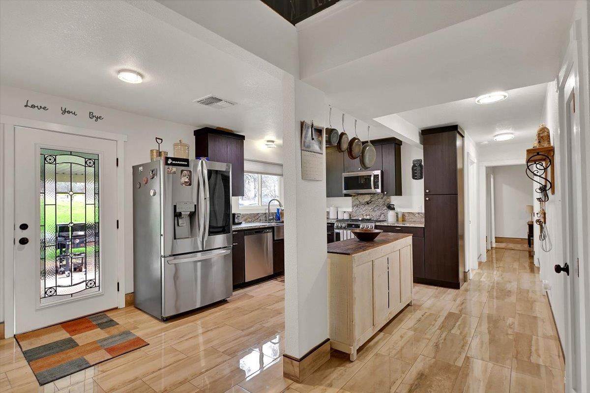 203 Tennessee Lane Bangor, CA 95901 - Photo 11 of 54 a kitchen with stainless steel appliances kitchen island granite countertop a refrigerator and a stove
