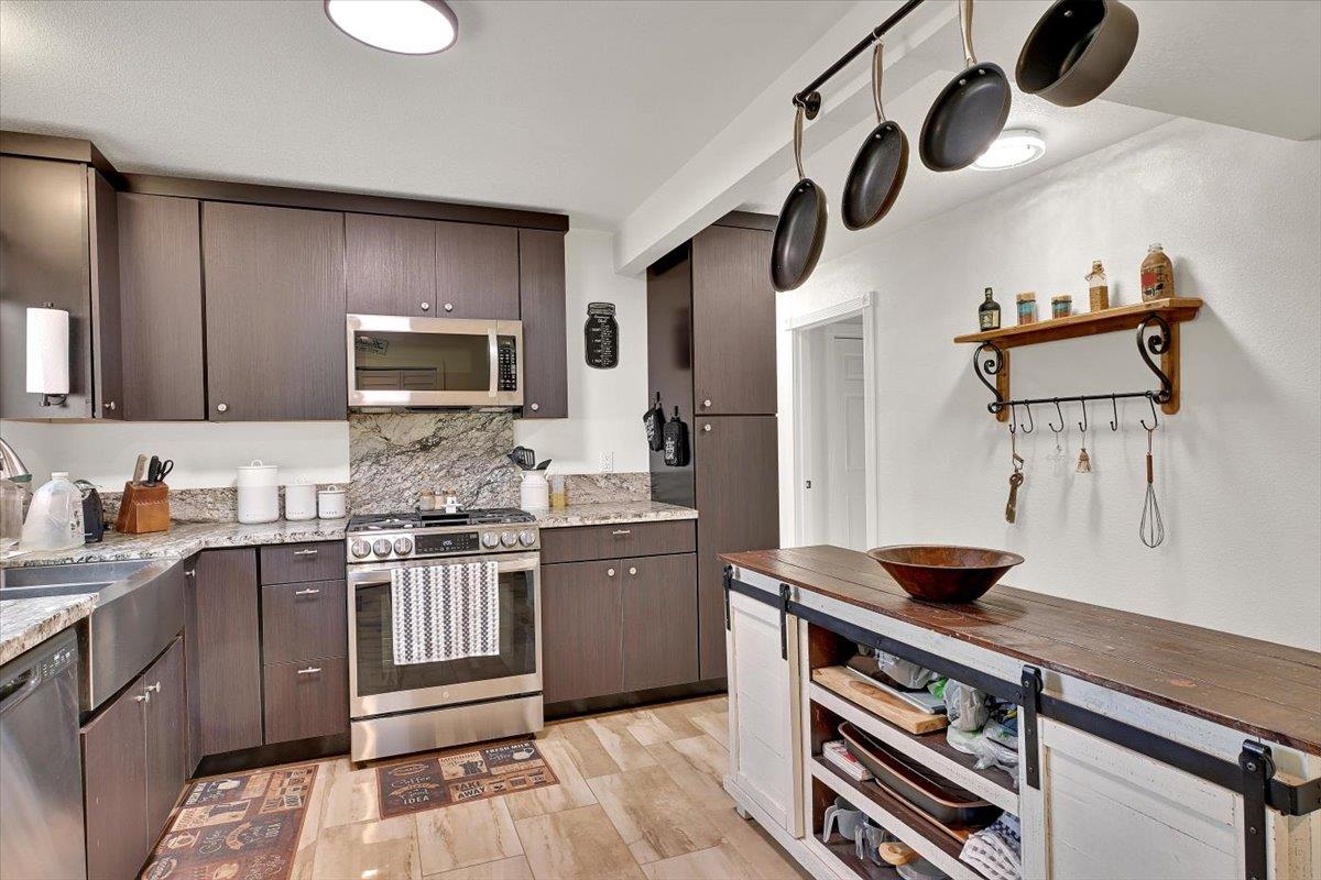 203 Tennessee Lane Bangor, CA 95901 - Photo 14 of 54 a kitchen with stainless steel appliances granite countertop a sink and a stove