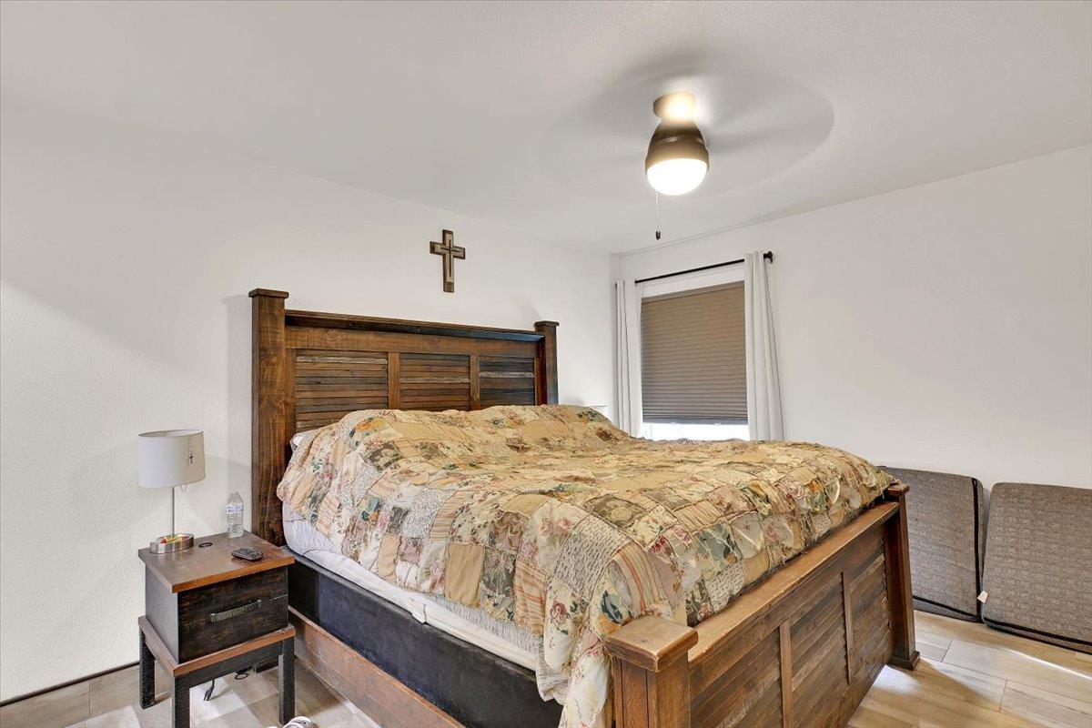 203 Tennessee Lane Bangor, CA 95901 - Photo 19 of 54 a bedroom with a bed and a chandelier