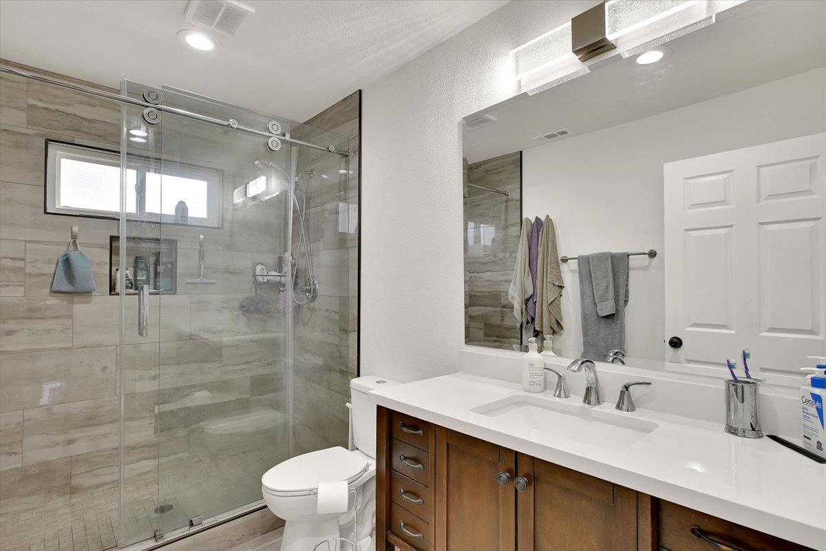 203 Tennessee Lane Bangor, CA 95901 - Photo 20 of 54 a bathroom with a granite countertop sink a toilet a mirror and shower