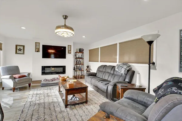 a living room with furniture fireplace and flat screen tv