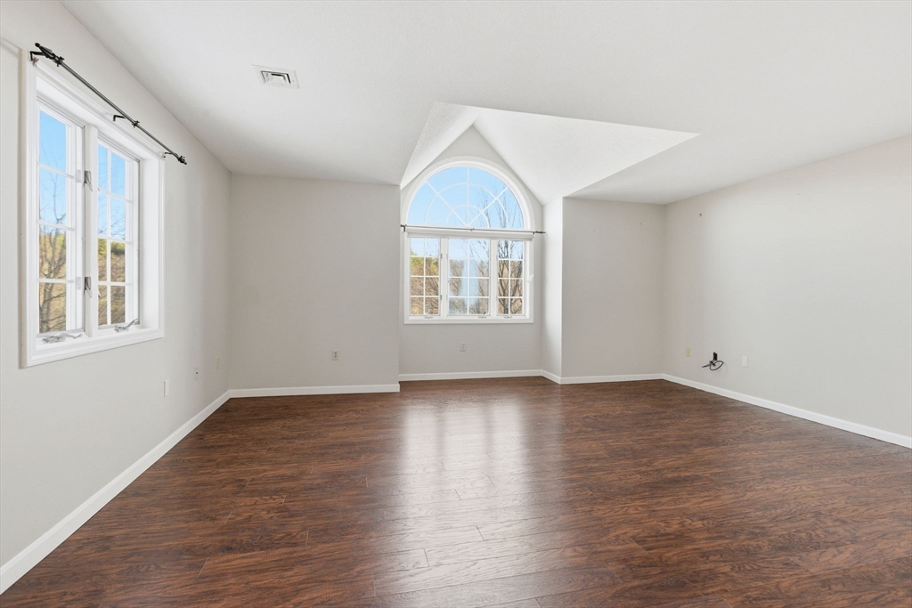 18 Palmer Road, Unit 6 Monson, MA 01057 - Photo 11 of 42 an empty room with wooden floor windows and cabinet