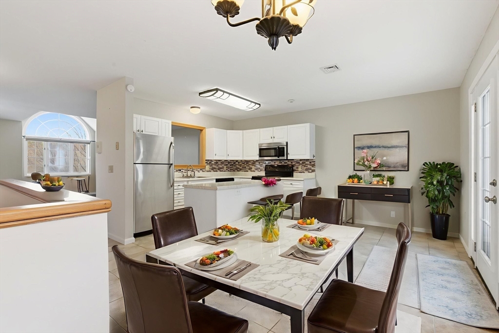 18 Palmer Road, Unit 6 Monson, MA 01057 - Photo 14 of 42 a view of a dining room with furniture and a chandelier