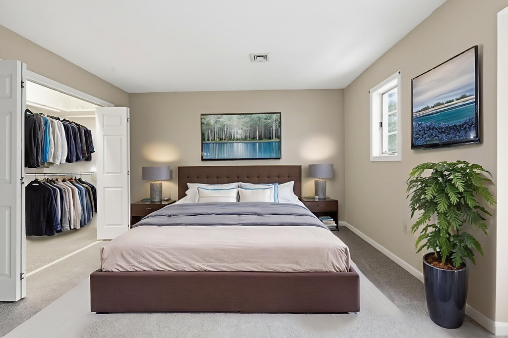 18 Palmer Road, Unit 6 Monson, MA 01057 - Photo 32 of 42 a bedroom with a bed a mirror and desk