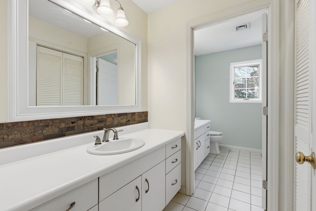 18 Palmer Road, Unit 6 Monson, MA 01057 - Photo 35 of 42 a bathroom with a sink toilet and mirror
