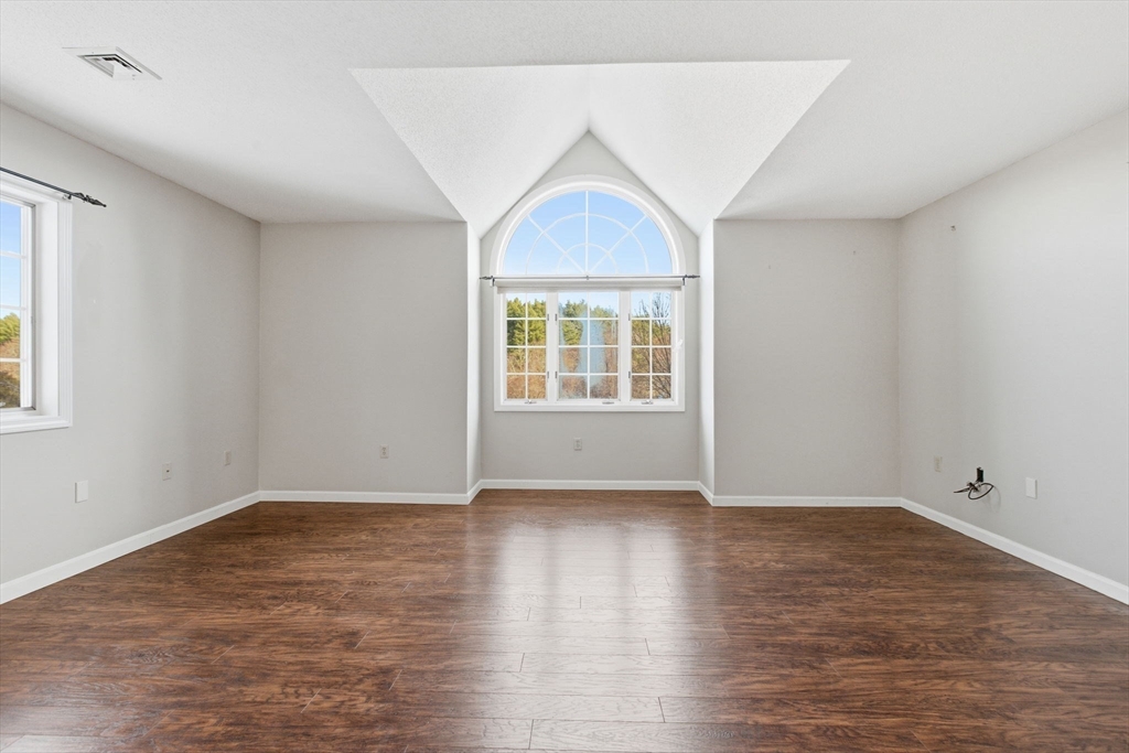 18 Palmer Road, Unit 6 Monson, MA 01057 - Photo 5 of 42 a view of an empty room with wooden floor and a window