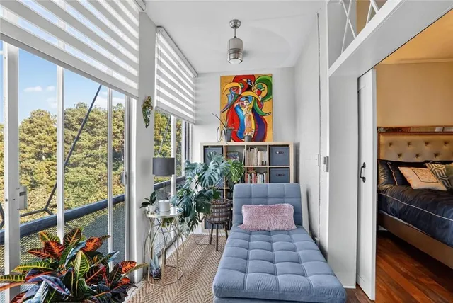 a hallway with beautiful frames and flower vase