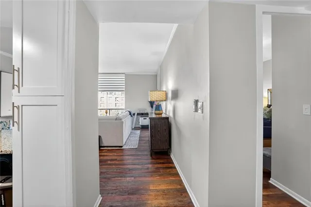 a view of a hallway with wooden floor and staircase