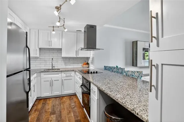 a kitchen with a sink stove and refrigerator
