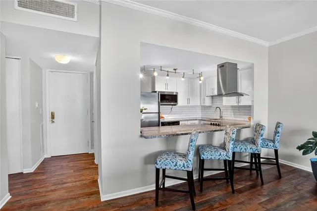 a dining room with furniture and wooden floor