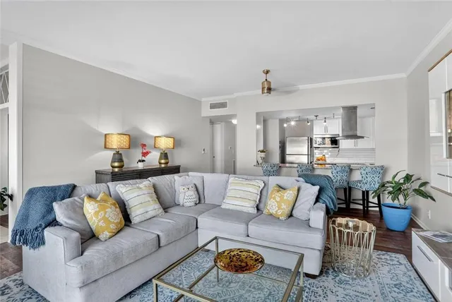 a living room with furniture and kitchen view