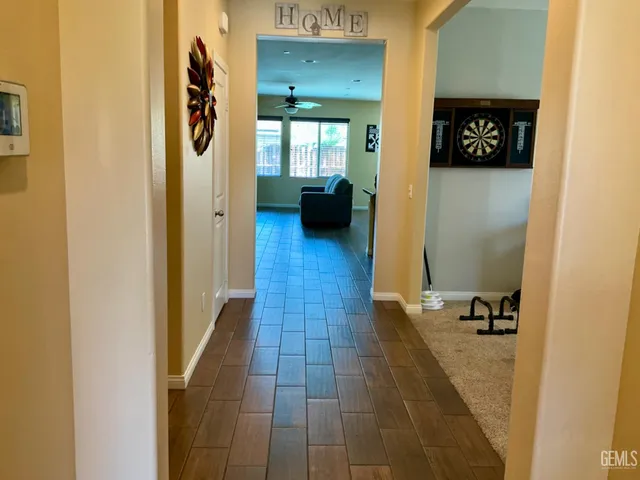 a view of hallway with livingroom and wooden floor