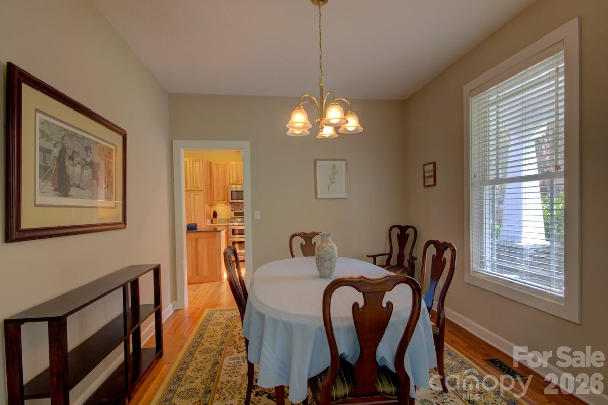 751 Everett Road Pisgah Forest, NC 28768 - Photo 12 of 36 a view of a dining room with furniture and chandelier