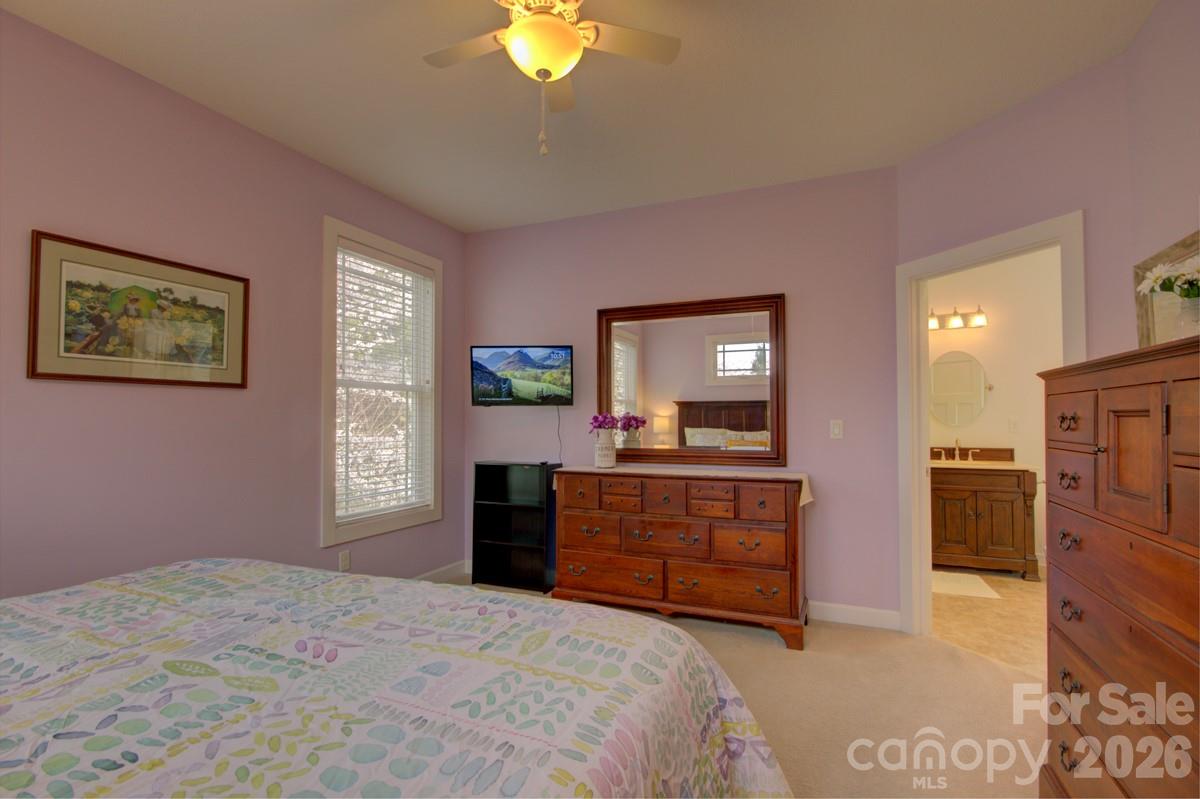 751 Everett Road Pisgah Forest, NC 28768 - Photo 28 of 36 a bedroom with a bed and a dresser