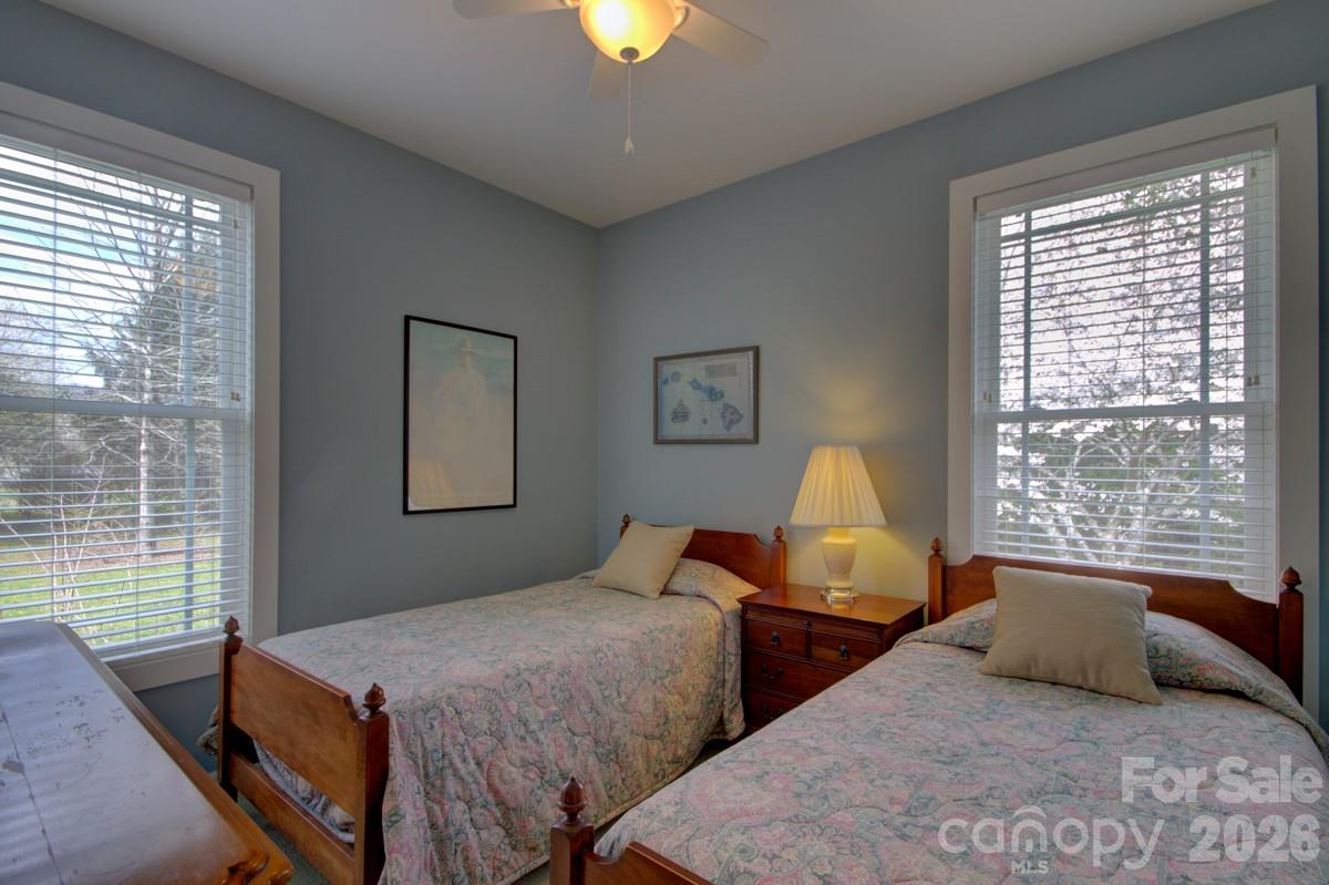 751 Everett Road Pisgah Forest, NC 28768 - Photo 8 of 36 a bedroom with two beds and a window