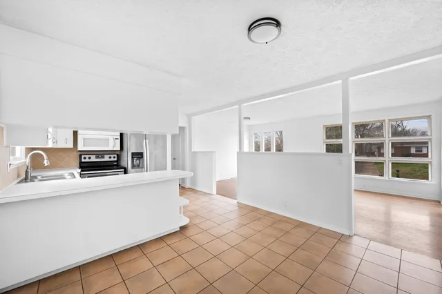 a kitchen with stainless steel appliances cabinets a sink and a counter top space