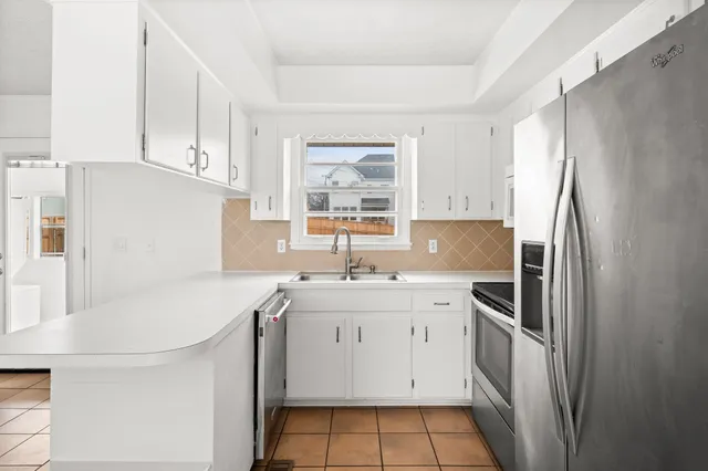 a kitchen with a sink appliances and cabinets