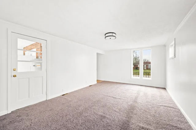 a view of room with wooden floor and fan
