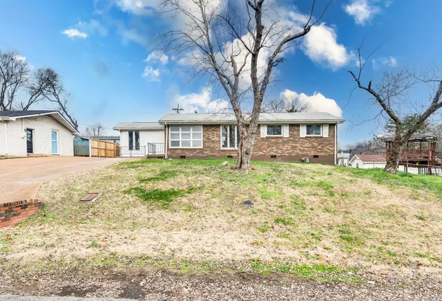 a house with tall trees in the background