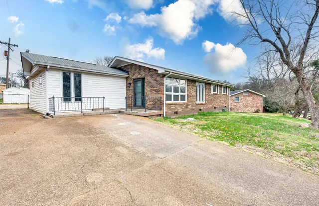 a front view of house with yard and green space