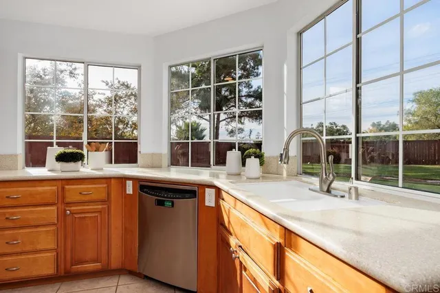 a kitchen with a sink and large window