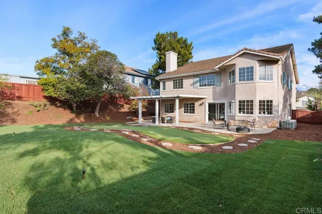 a view of a house with a yard patio and swimming pool