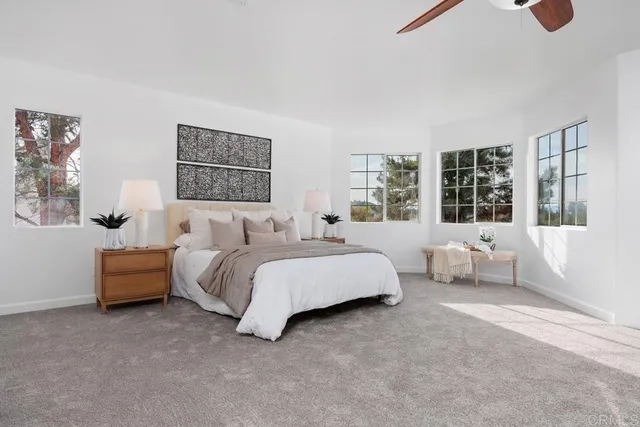 a spacious bedroom with bed and a couch