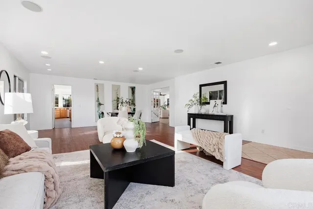 a living room with furniture and painting on the wall