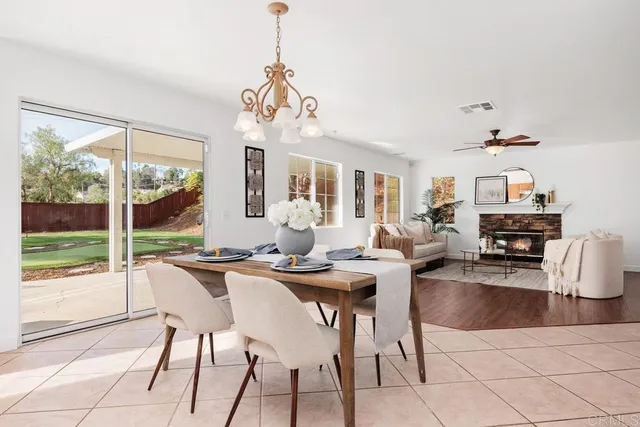 a view of a dining room with furniture wooden floor and chandelier