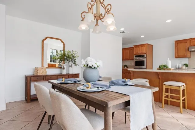a view of a dining room with furniture and chandelier