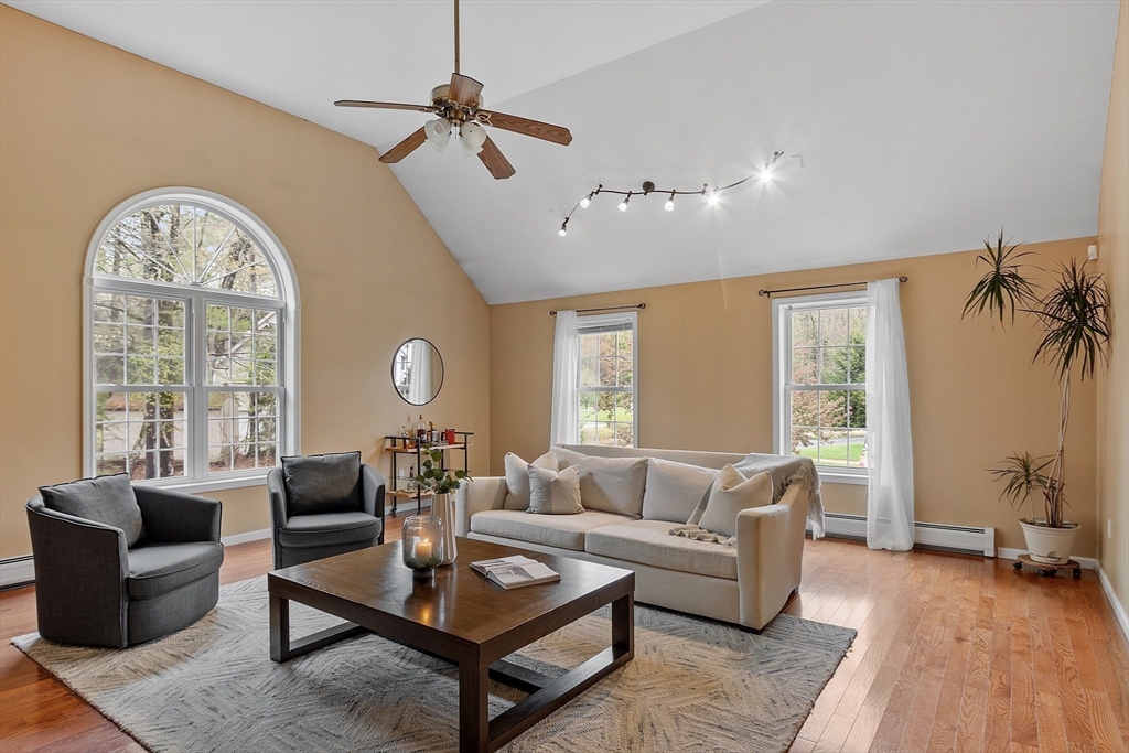 30 Page Epping, NH 03042 - Photo 12 of 42 a living room with furniture a chandelier and a large window