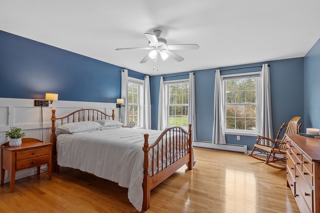 30 Page Epping, NH 03042 - Photo 17 of 42 a bedroom with a bed and a chandelier